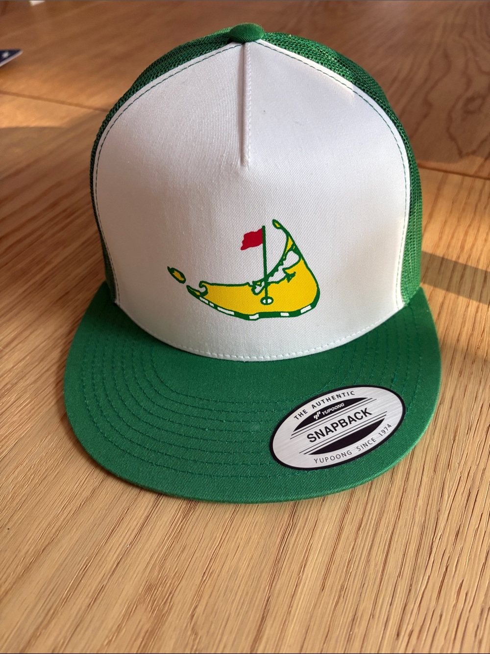 The Classic White and Green Trucker Hat with Nantucket masters Graphic
